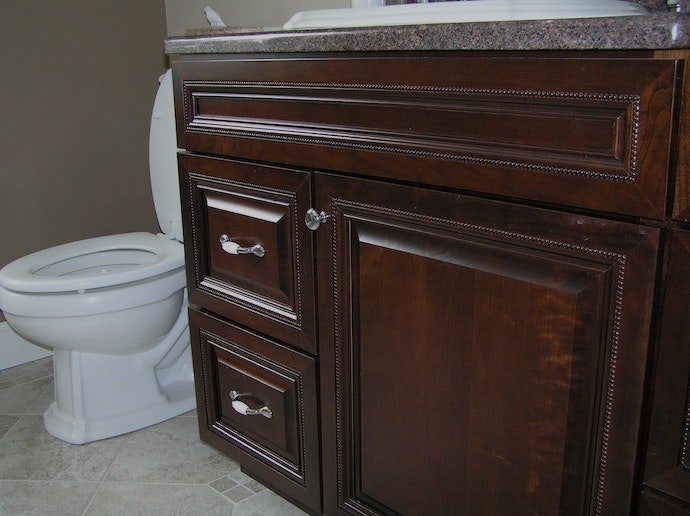 Renovated bathroom cabinets, tile flooring and granite countertop