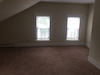 Freshly painted apartment with wood flooring and an emergency exit