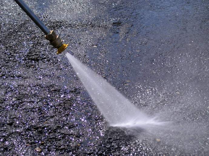 Pressure washer up close cleaning asphault