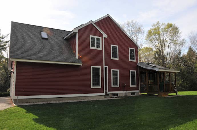 Siding installed on large red single family home